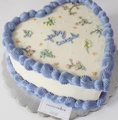 a blue and white cake on a silver platter