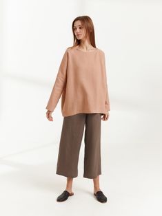 "RUMI is a long sleeve loose fit linen blouse. DETAILS - Oversized fit - Long sleeves - Boat neckline - 100% lightweight European linen fabric - Cut and sewn to order just for you in our studio COLOR - Camel, you can also choose other colors above - Fabric samples are available here https://www.etsy.com/listing/586569696/linen-fabric-samples SIZING & FIT - Relaxed, loose fit - Length is approximately 26 inches / 66 cm - Bust is approximately 26.5 inches / 67 cm - Measurements taken from a si Casual Long Sleeve Flax Blouse, Beige Relaxed Fit Tunic For Fall, Versatile Long Sleeve Neutral Top, Oversized Long Sleeve Beige Tunic, Oversized Beige Long Sleeve Tunic, Beige Long Sleeve Fall Tunic, Relaxed Fit Long Sleeve Blouse In Flax Color, Flax Long Sleeve Relaxed Fit Blouse, Versatile Long Sleeve Beige Blouse