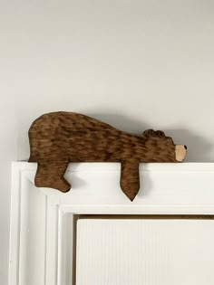 a wooden bear is hanging on the door