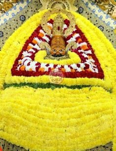 the idol is made up of yellow and red flowers