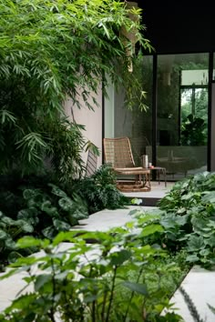 a chair sitting on top of a patio surrounded by greenery