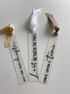 three ribbons with writing on them sitting next to each other in front of a white background