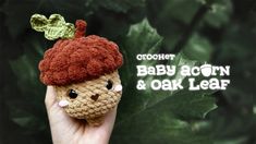 a crochet baby acorn and oak leaf brooch sits on someone's hand