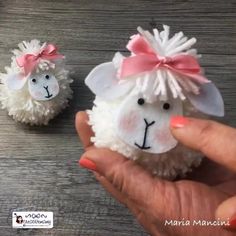 two sheep made out of toilet paper with pink bows on their heads, one is white and the other is black