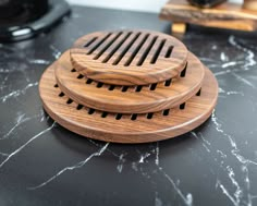 three wooden graters sitting on top of a black counter