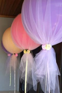 several pictures of balloons with flowers and tulle attached to the back of each balloon