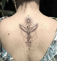 the back of a woman's neck with a bird and star tattoo on it