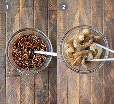 two glass bowls filled with food sitting on top of a wooden table next to each other