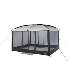 a tent that is sitting on top of a white surface with mesh covering it's sides