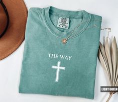 Product: Comfort Colors The Way Cross T-Shirt Christian Gift Jesus Tee Trending Christian Tee Bible Verse Religious Shirt Religious Tee ✦ MAKE IT PERFECT and Customize this shirt for FREE! Just shoot us a message BEFORE purchasing and we will work with you to create a design you'll love. ✦ SIZING CHART Please refer to the sizing chart in the pictures above to find your perfect fit! Simply lay your favorite T-shirt flat and measure armpit to armpit then compare it to the size chart image provided Jesus Tees, Church Shirt, Christian Tees, Jesus Loves You, Jesus Loves, Christian Shirts, Christian Gifts, Tshirt Colors, Christmas Shirts