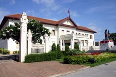 a large white house sitting on top of a lush green field