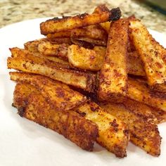 french fries on a white plate sitting on a counter