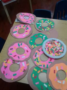 paper plates and doughnuts are arranged on a table