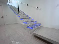 there is a set of stairs with blue lights on the bottom and bottom treads