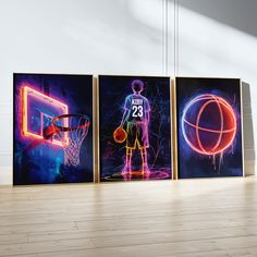 three basketball posters on the wall in an empty room