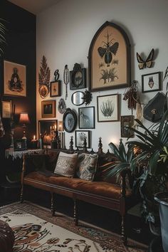 a living room filled with lots of pictures and plants on the wall next to a couch