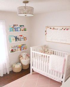 a baby's room with a crib and bookshelves on the wall