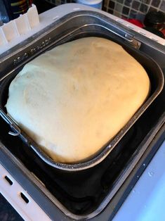 an uncooked loaf of bread in a pan on top of the stovetop