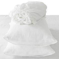 three white pillows stacked on top of each other