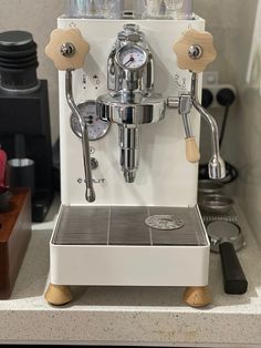 a white coffee machine sitting on top of a counter