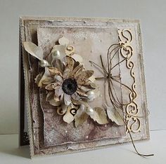 a close up of a greeting card with flowers and ribbons on the front, along with an embellishment in the middle