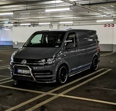 a grey van parked in a parking garage