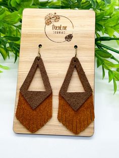 Brown Cognac Genuine Suede Leather Earrings Beautiful, lightweight triangle fringe earrings made of brown and cognac genuine suede leather.  The perfect Fall to Winter accessory, dress them down for the office or glam them up for a night on the town! Trendy, boho, and unique, these earrings are sure to make a statement with any outfit! Each pair is made to order and pattern placement may vary from pictured. Earring wires are made of surgical stainless steel with an antique bronze finish, making them hypoallergenic and great for sensitive ears.  Earring Features: * Genuine suede leather * Surgical stainless steel antique bronze ear wires with clear backs * Measures approximately 2.5 inches in length * Lightweight *Please Note: I try my best to capture the most accurate colors of materials. Brown Fringe Tassel Earrings As Gift, Brown Fringe Tassel Earrings For Gift, Brown Fringed Tassel Earrings Gift, Brown Dangle Earrings With Tassels, Elegant Brown Adjustable Tassel Earrings, Elegant Leather Fringe Jewelry, Triangle Leather Earrings, Brown Fringe Dangle Jewelry, Minimalist Brown Leather Earrings