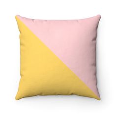 a pink and yellow pillow sitting on top of a white wall