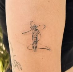 a person with a hat and a surfboard on their arm