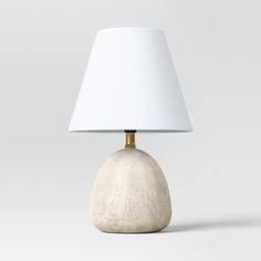 a table lamp with a white shade on it