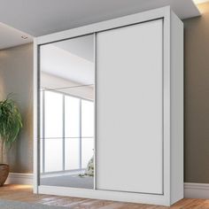 an empty room with a potted plant on the floor and a sliding glass door