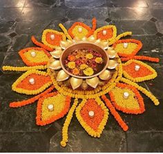 a decorative flower arrangement with candles and flowers on the floor for diwaling or decorating