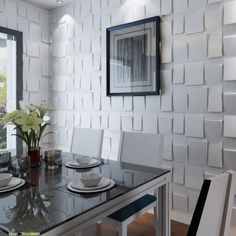 a dining room table with white chairs and plates on it, in front of a large window