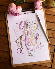 a clipboard with the words go to hell on it next to some pink flowers