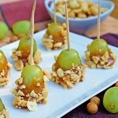 an image of food on a plate with nuts and green apples in the middle,