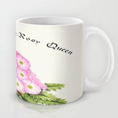 a white coffee mug with pink flowers and the words rosy queen on it's side