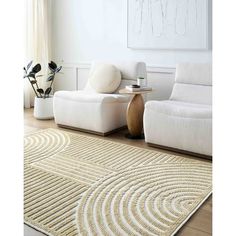 a living room with white furniture and rugs