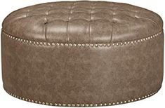 a round ottoman with studded trimmings and buttons on the top, sitting in front of a white background