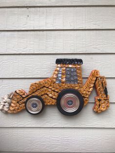 a truck made out of chains on the side of a house