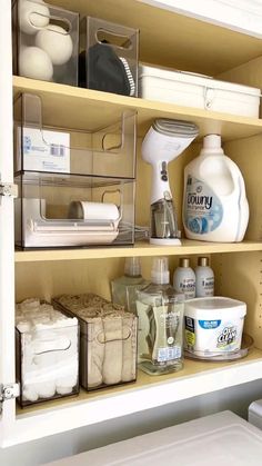 an organized bathroom cabinet filled with toiletries and cleaning products