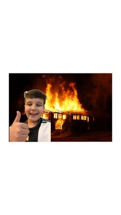 a boy giving the thumbs up in front of a house on fire