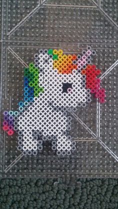 an image of a cross - stitch unicorn with a rainbow on it's head