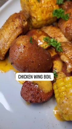 chicken wing boil with corn on the cob, and some type of meat in it