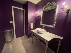 a bathroom with purple walls and a white sink