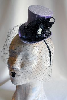 This victorian goth mini top hat is a simple yet elegant piece.It is covered with black silk shantung and adorned with black satin ribbon in a vertical half bow, vintage black cotton lace in a rosette, pleated satin ribbon, which forms an oval frame for a beautiful black and white victorian profile cameo. Choose between with or without black veil. Also available in a white and black combination: https://www.etsy.com/bizarrenoir/listing/166826619/gothic-mini-top-hat-in-purple-velvet?ref=shop_home Gothic Headpieces For Halloween Evening, Steampunk Headpiece, Top Hat With Veil, Bridal Mini, White Wedding Decor, Hat With Veil, First Birthday Hats, White Gothic, Black Combination