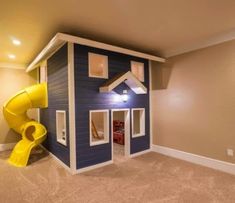 a child's playroom with a slide and playhouse