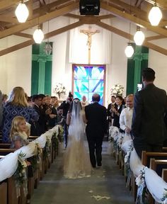 the bride and groom are walking down the aisle