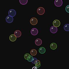 bubbles floating in the air on a black background, with one balloon being blown by the wind