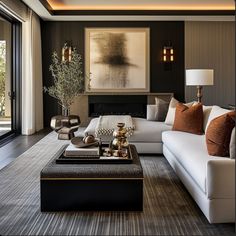 a living room filled with furniture and a painting on the wall above it's fireplace