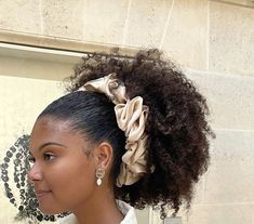 a close up of a person with a hair piece in her hair and wearing a white shirt